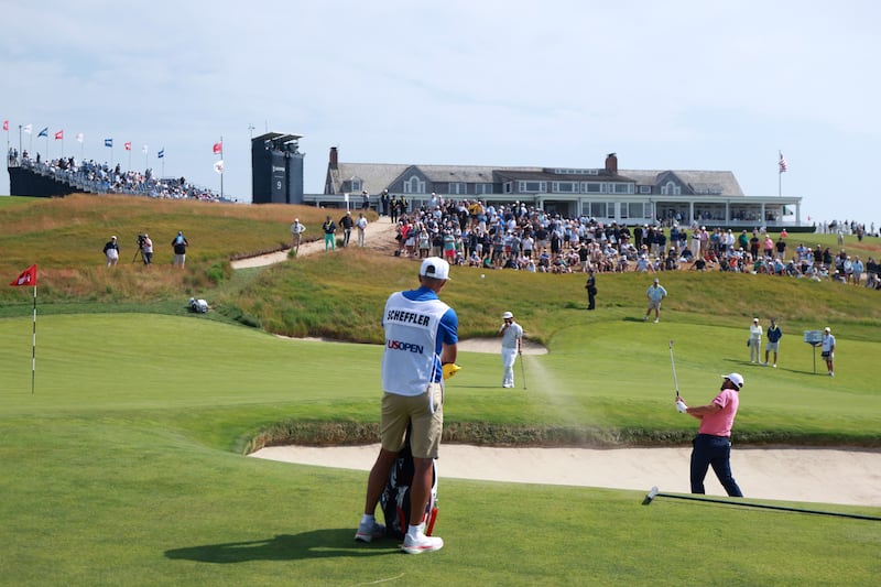 Scottie Scheffler plays a shot from the bunker on the 18th hole during the first round of the 126th US Open at Shinnecock Hills Golf Club on in New York on Thursday. Photograph: Andrew Redington/Getty