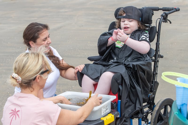 Tom with his mum Chantelle and Occupational Therapist Katie at Rossnowlagh beach, Co Donegal. Tom participated in the ocean to child pathway. Photograph: Darragh Gorman