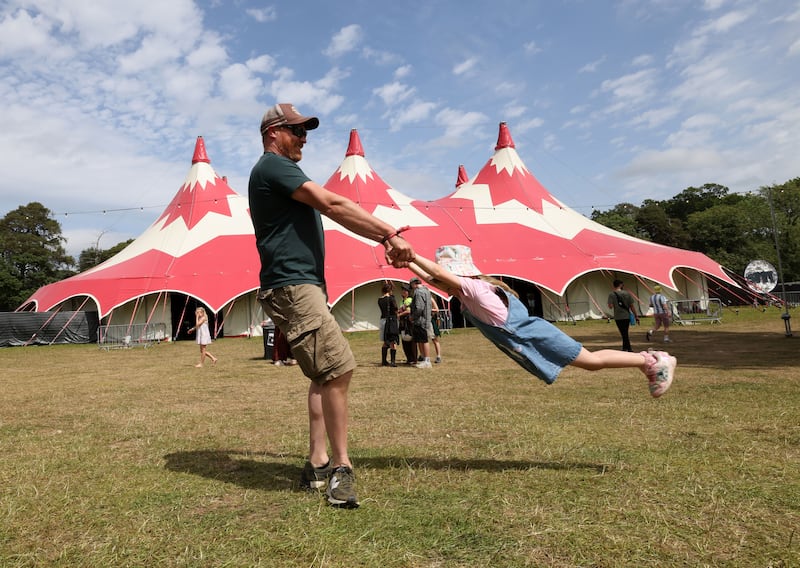 Diarmuid O'Briain swinging Eabha Ní Bhriain from Rathdrum at the 2026 Beyond the Pale festival 2026 in Glendalough estate, Co Wicklow. Photograph: Alan Betson

