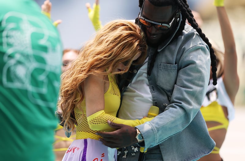 Shakira and Burna Boy embrace after the performance. Photo: Ryan Pierse/Fifa/Getty