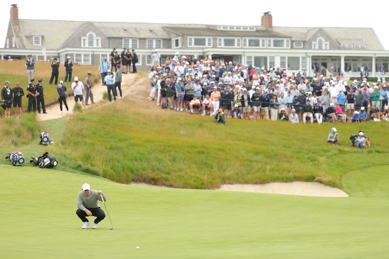 McIlroy lines up a putt on the 18th green. Photograph: Kate McShane/Getty