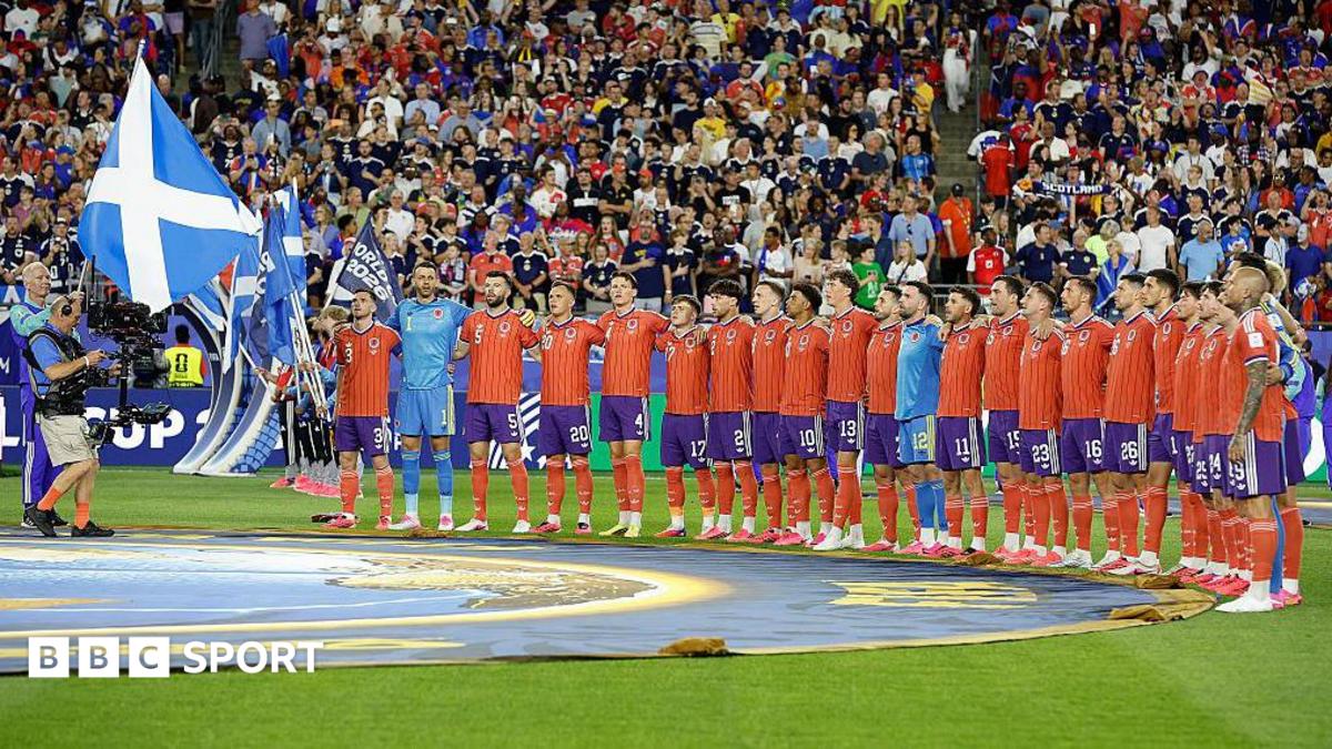 Scotland players prepare to sing the national anthem before their game against Haiti