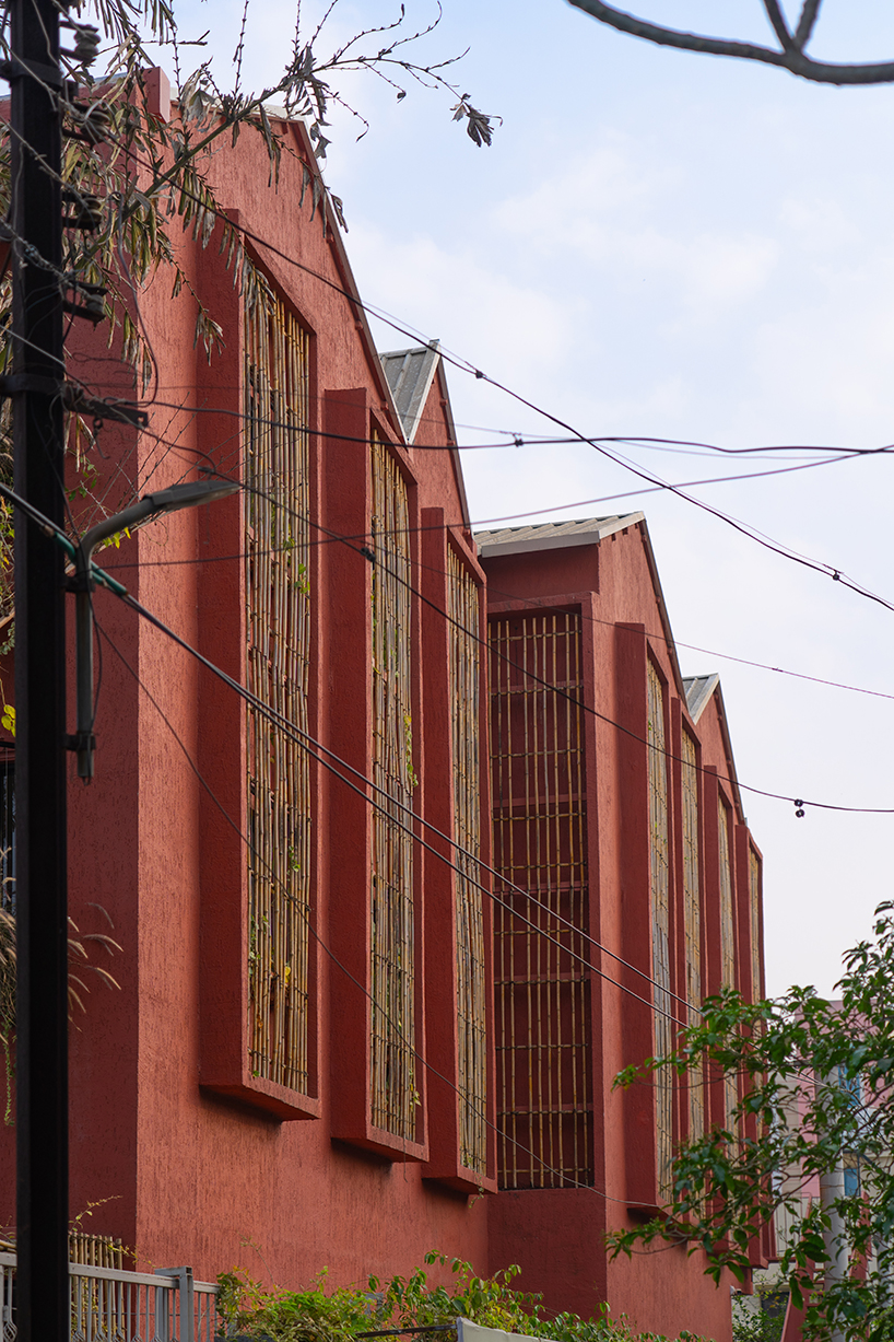 underused house reconfigures into child-centered bright red preschool in india - 4