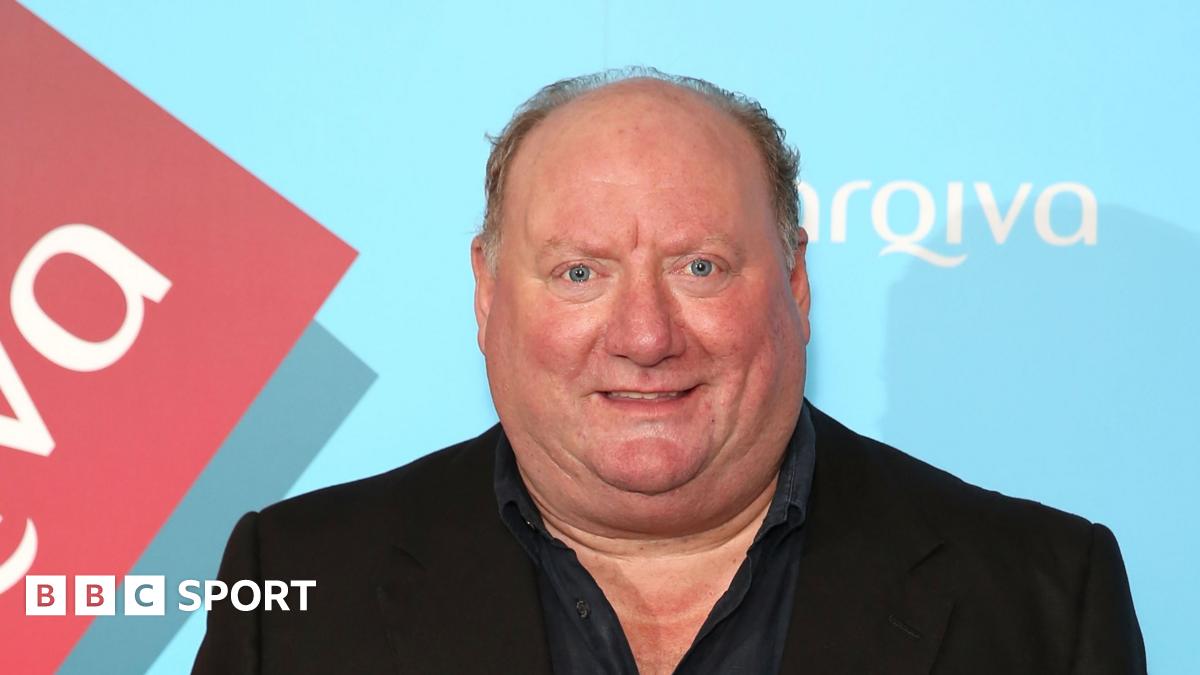 A picture of Alan Brazil wearing a blazer and shirt.