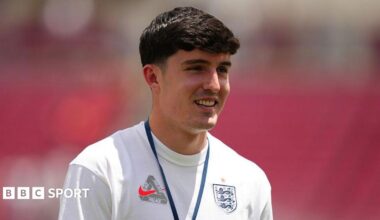 Tino Livramento, wearing a white England T-shirt, pictured smiling