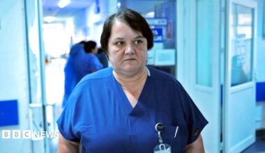 Surgeon Dr Oana Goidescu on shift at Buzău Hospital in blue scrubs. She has mid length black hair