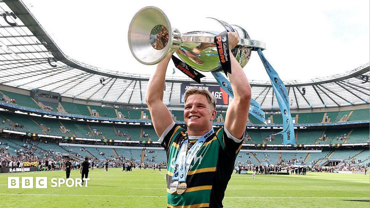 Northampton flanker Henry Pollock, wearing the club's yellow, green and black shirt, lifts the Prem Rugby trophy above his head