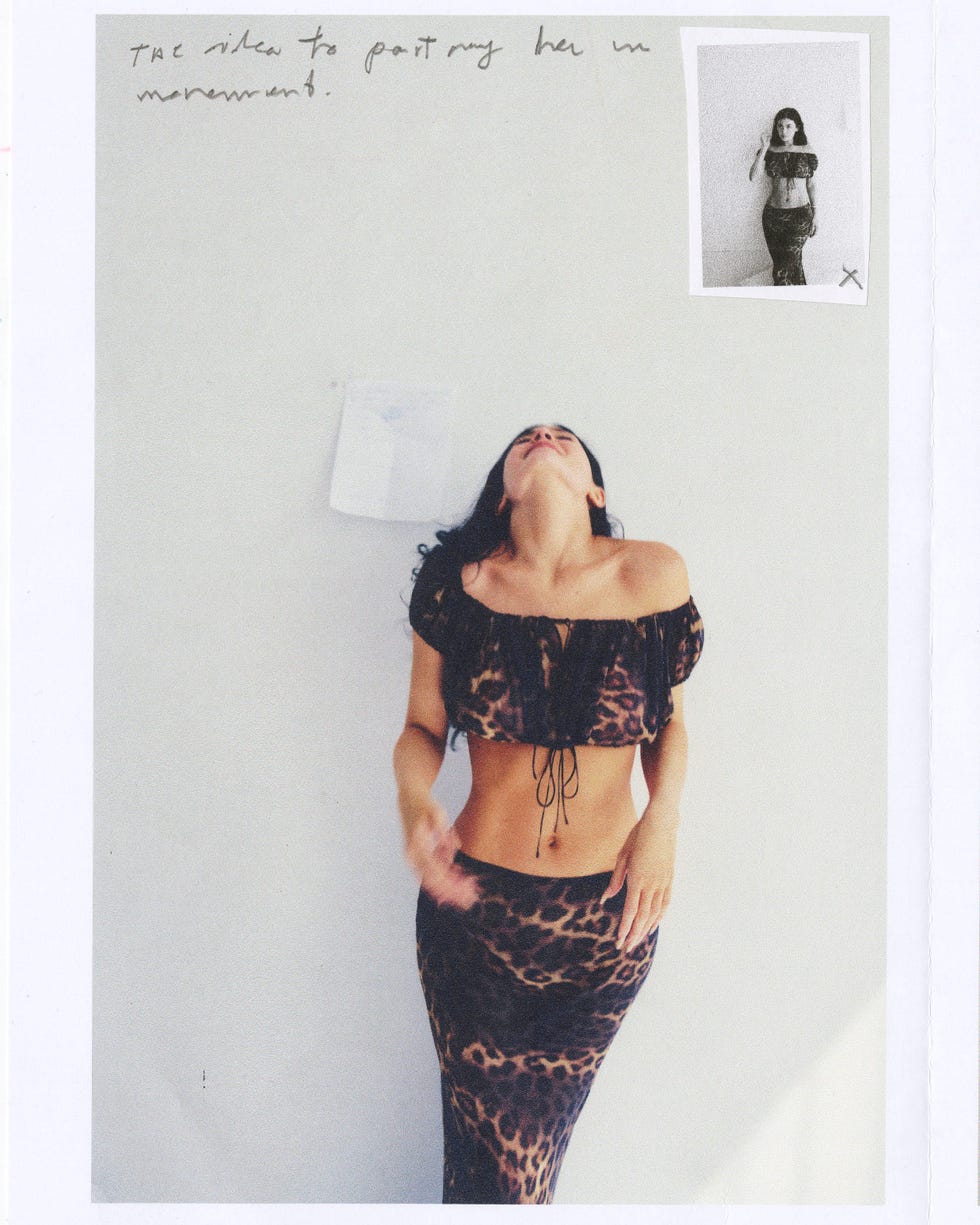 Woman in leopard print outfit, head tilted back, with a handwritten note and small black-and-white photo on the wall. Woman in leopard print outfit, head tilted back, with a handwritten note and small black-and-white photo on the wall.