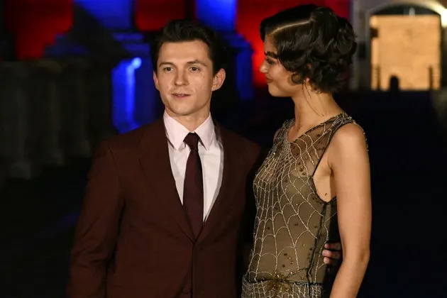Zendaya and Tom Holland posing during a red carpet event for