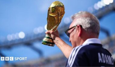 A Scotland supporter raises a replica FIFA World Cup Trophy in the stands prior to during the Group C match against Morocco