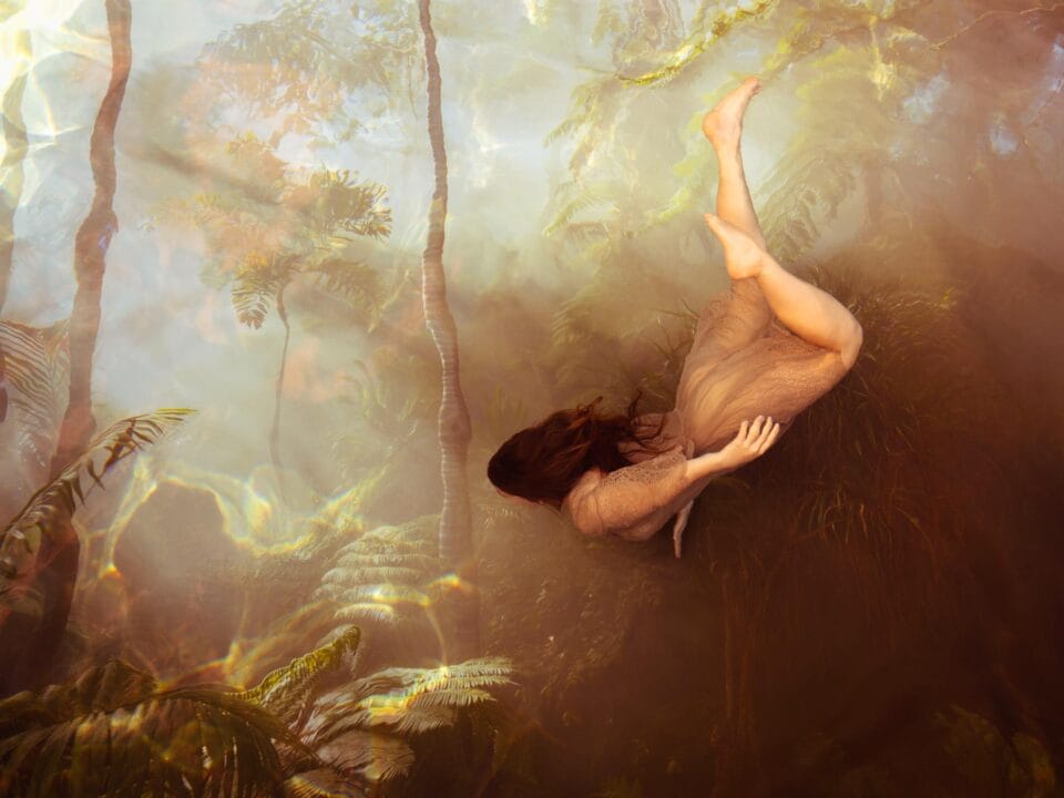 a photograph by Tamara Dean of a woman drifting underwater