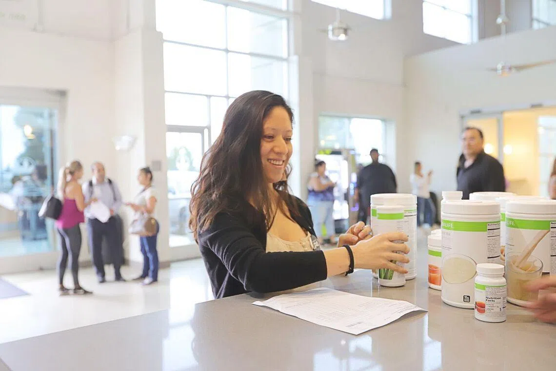 Asian woman buying Herbalife products