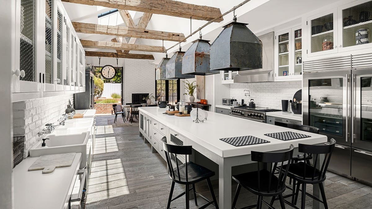 Diane Keaton's former kitchen with a large center island and white cabinetry