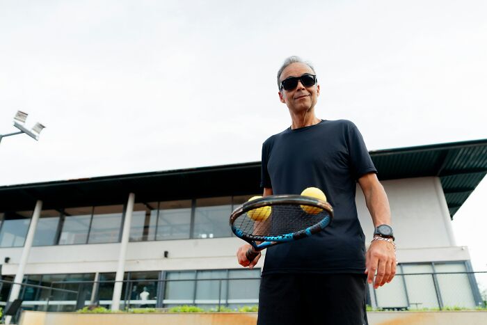 A man with sunglasses and a tennis racket, holding tennis balls. Nurses are puzzled by patient occurrences.