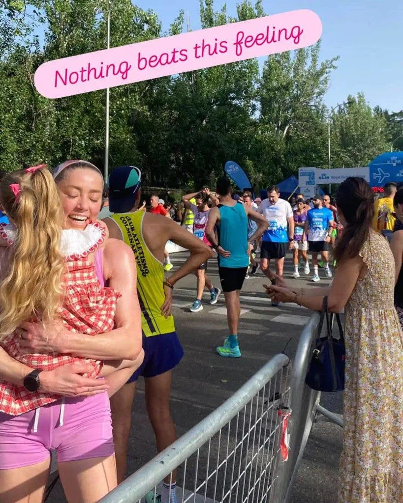 Amber celebrates finishing with a hug from her daughter, Oonagh