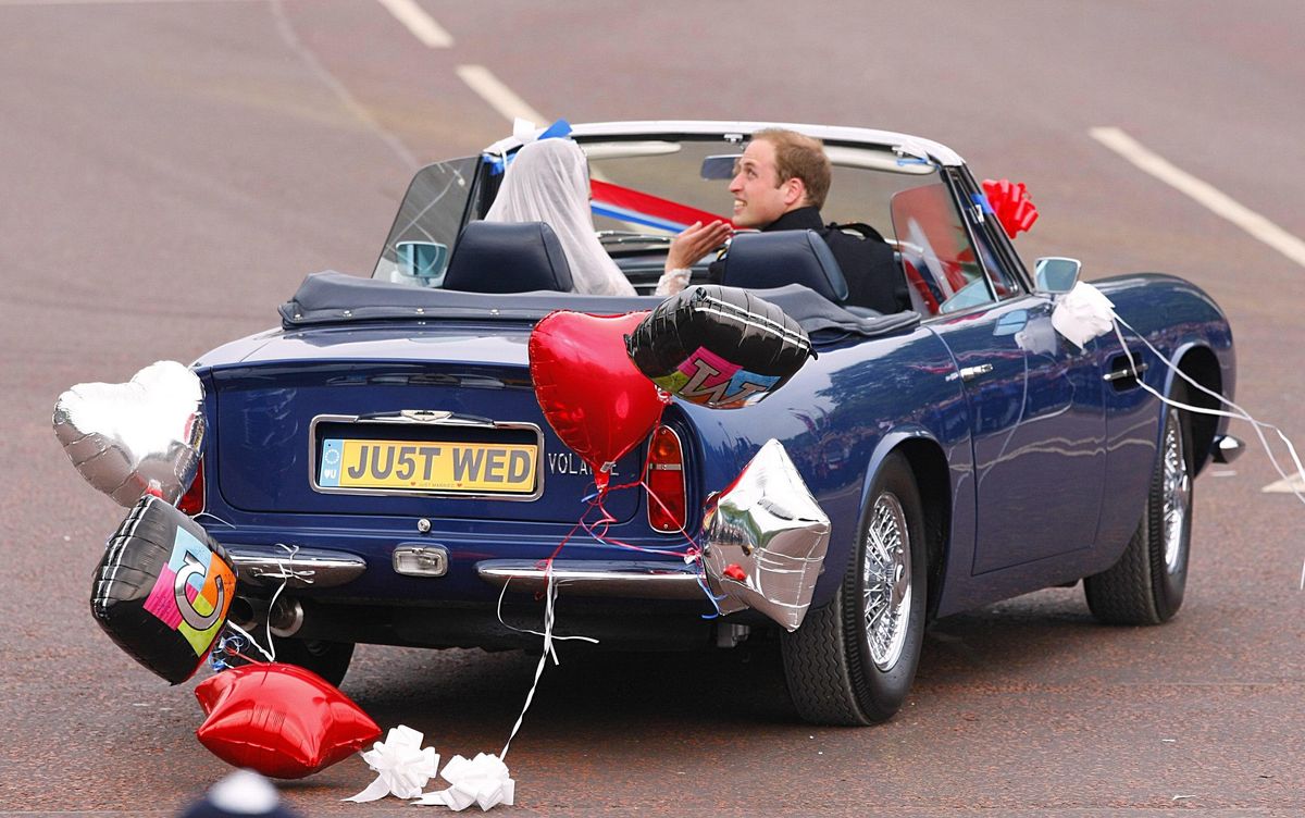 Prince William drives himself and his wife Kate as they leave Buckingham Palace for Clarence House.