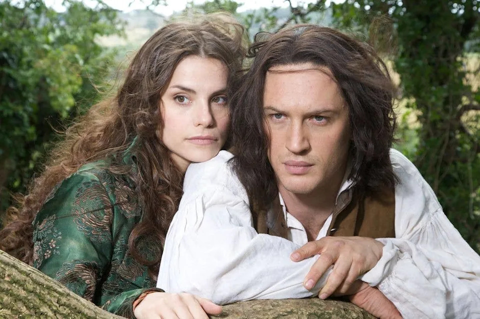 Man and woman leaning on tree branch