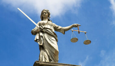 Why have solicitors taken industrial action against a government plan to reform legal aid?