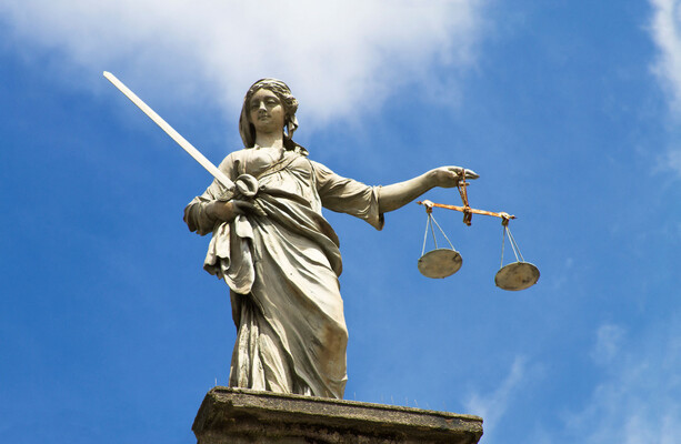 Why have solicitors taken industrial action against a government plan to reform legal aid?