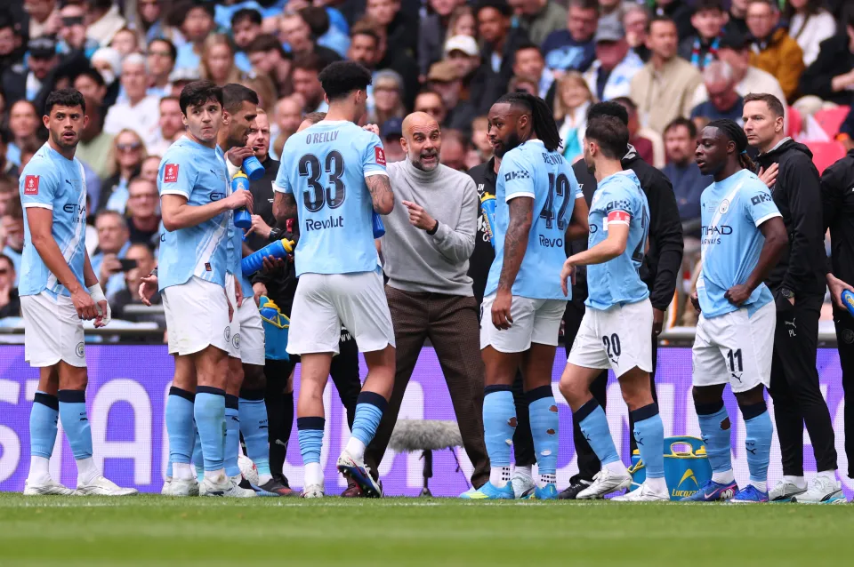 Manchester City manager Pep Guardiola speaks to his players durng an injury break during the Emirates FA Cup Final match between Chelsea and Manchester City