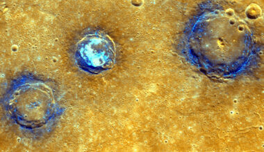 An image of the surface of Mercury shows a yellow surface and three craters ringed with dark blue. The middle crater has light blue spots in the center, and the other two are dotted with light blue around the edges.