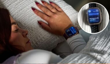 A close up of a dark haired woman asleep, with her head resting on a white pillow and with a white duvet placed over her. On her wrist, we see an Apple Watch tracking her sleep.