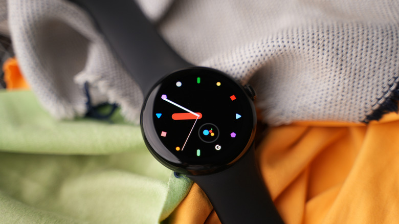 original Pixel Watch on display on top of a set of bedsheets