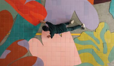 a person crawls atop colorful ceramic tiles on a floor