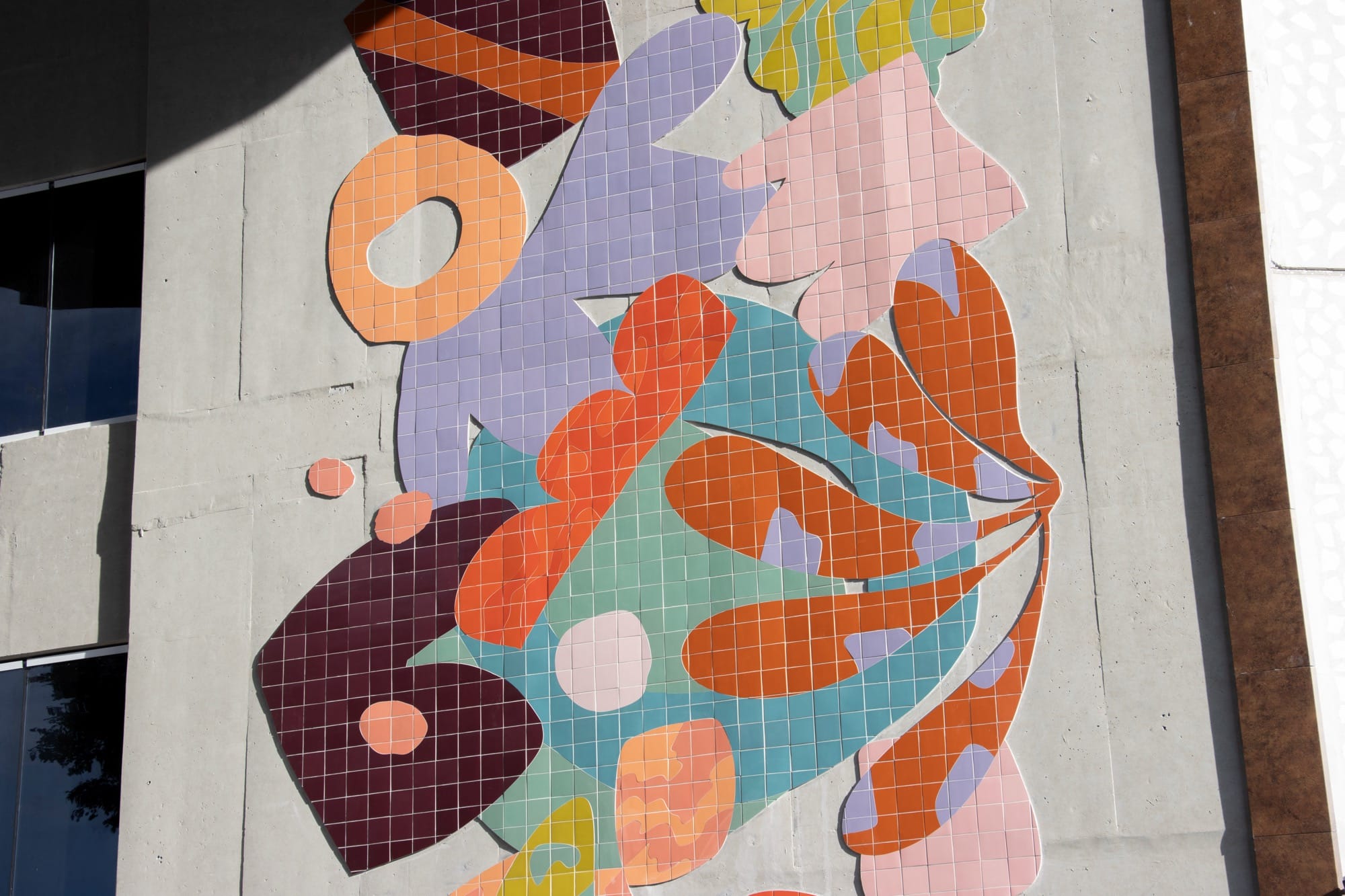 a mural by Alex Proba of colorful ceramic tiles in the shape of plants