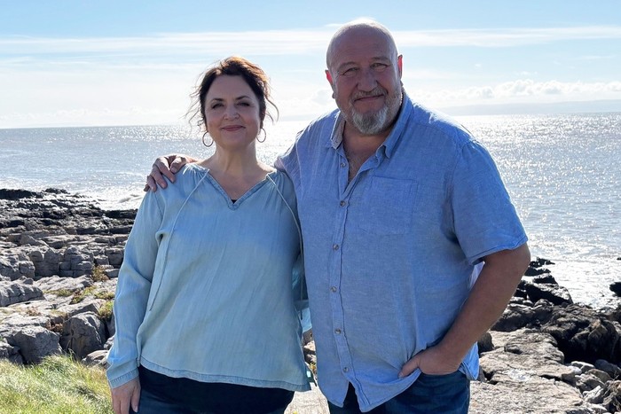 ruth-jones-steve-speirs Ruth Jones and Steve Speirs photographed smiling shoulder-to-shoulder on a sunny clifftop