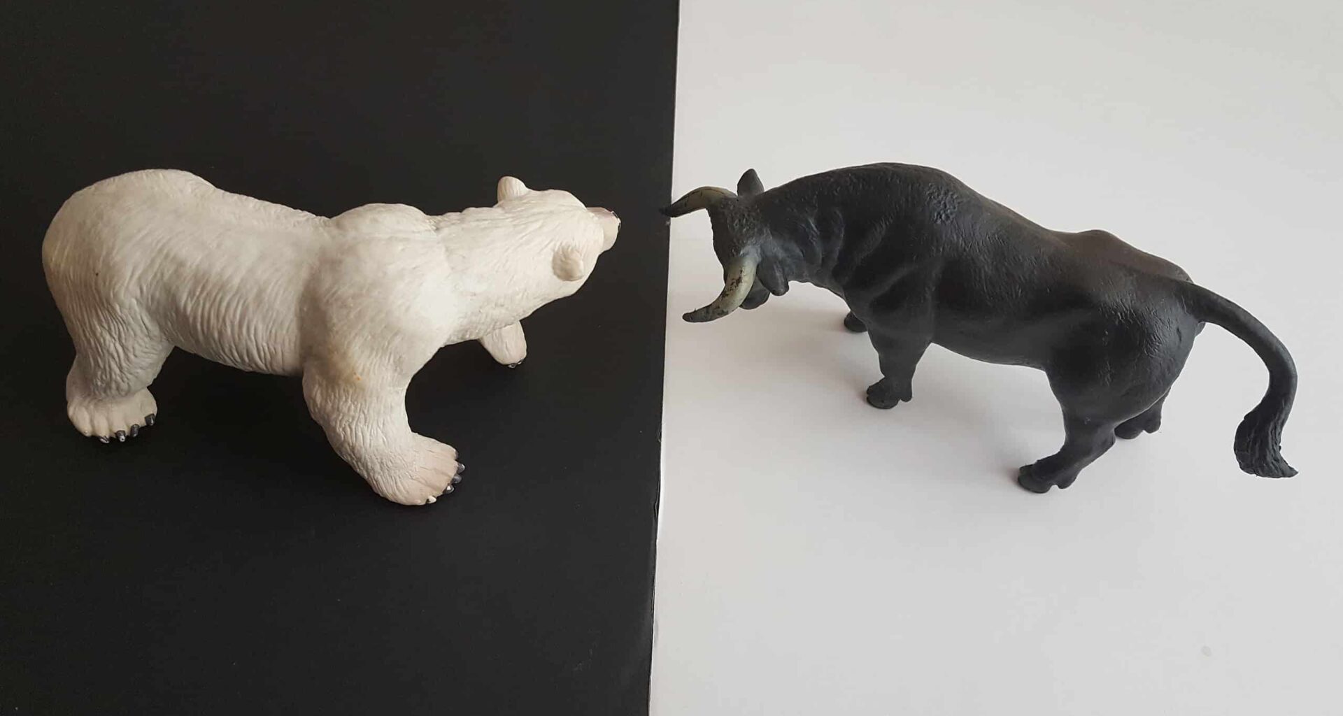 Animal figurines representing competition or conflict in a financial context.