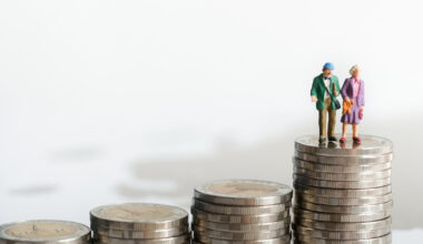 Figures of old man and woman on top of coins