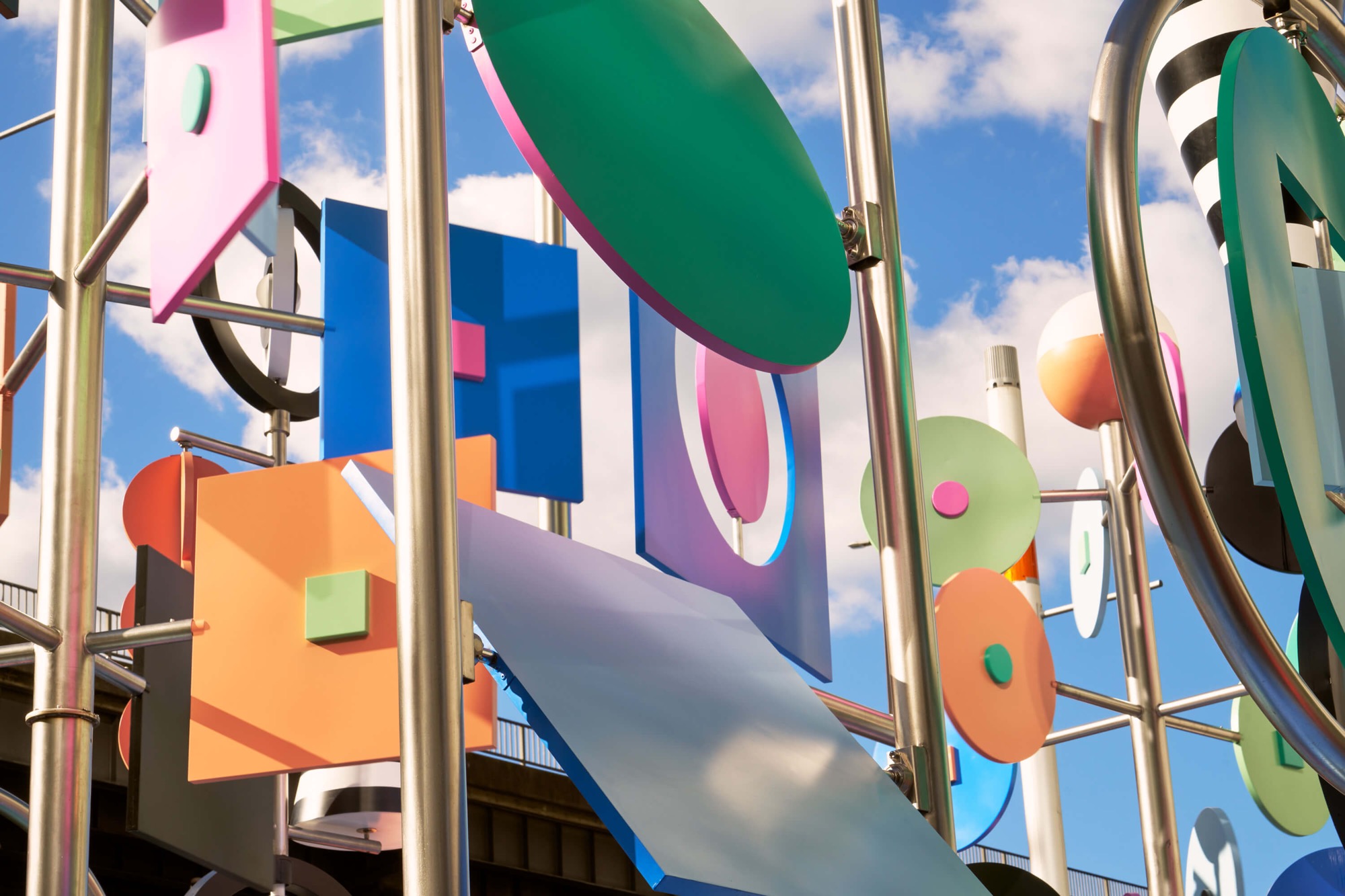 a detail photo of a colorful outdoor sculpture with twirling shapes by Wade and Leta