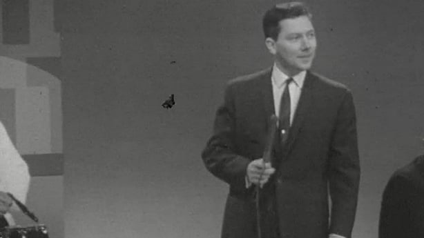 Black and white still shot of Gay Byrne from the Late Late Show