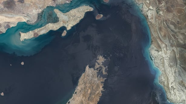 Sentinel-2 satellite imagery shows a broad overview of the Strait of Hormuz, including the Musandam Peninsula, nearby islands, coastal shallows, and the narrow maritime corridor linking the Persian Gulf with the Gulf of Oman. The image documents one of the world's most strategically important shippi