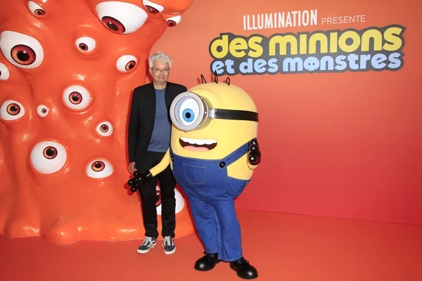 PARIS, FRANCE - JUNE 23: Pierre Coffin poses with a Minion at the