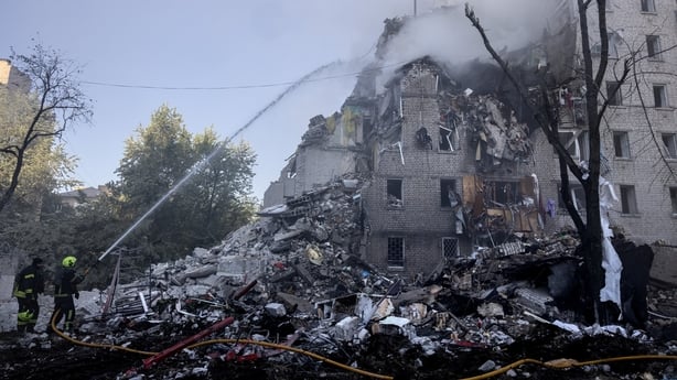 Firefighters work at a building that collapsed