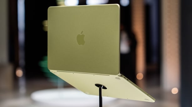 a yellow Apple Macbook Neo on display