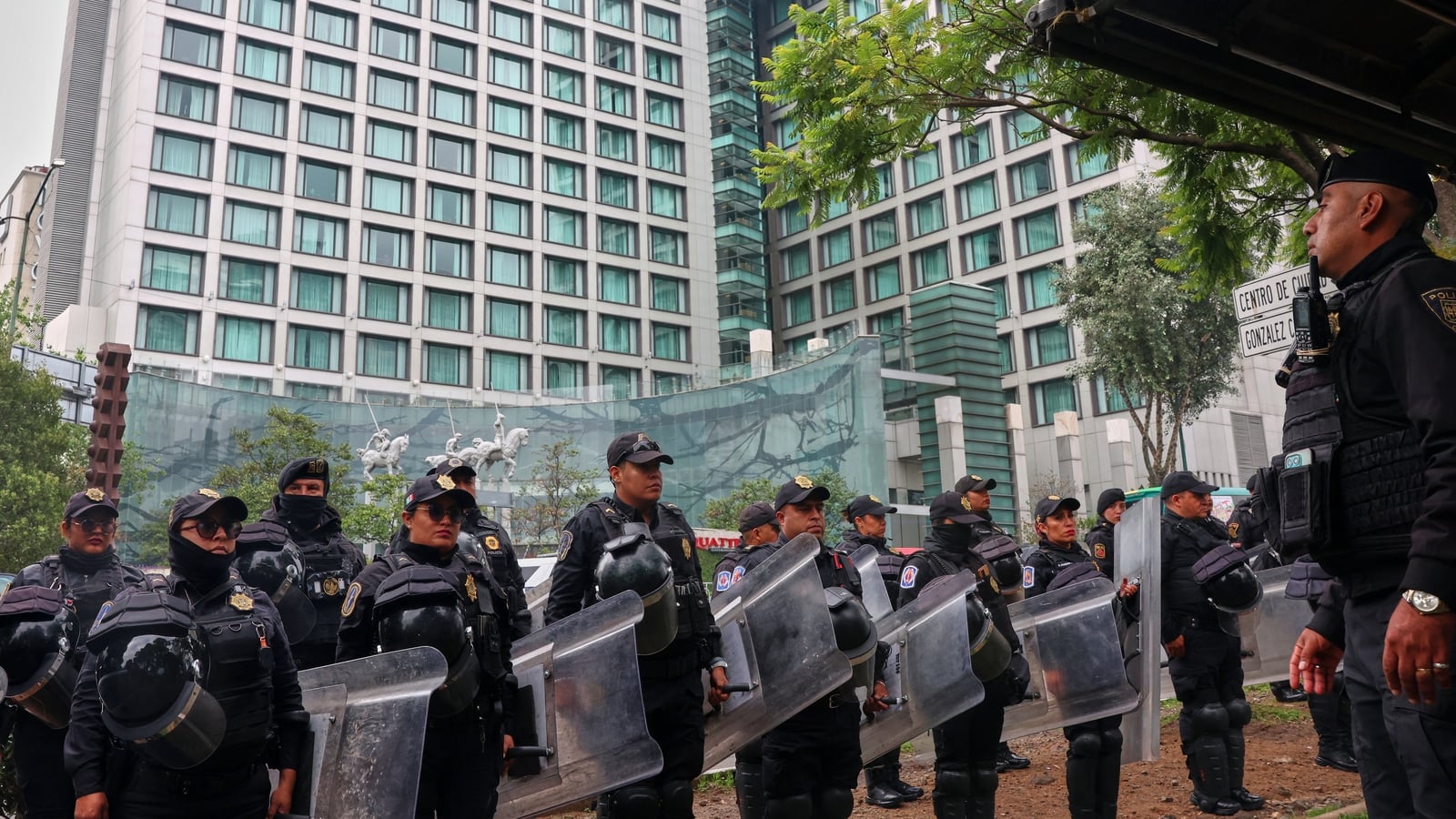 Riot police guard England team hotel in Mexico City
