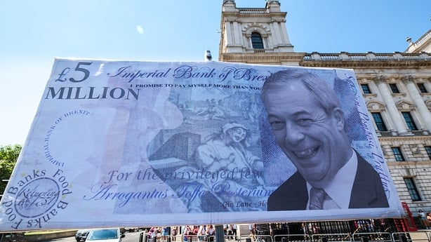 A photo of a poster showing a man imposed on a 5 pound note in the foreground with central London in the background