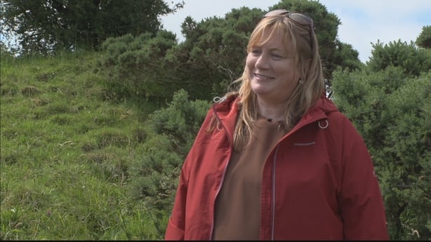 Dr Niamh Daly standing in a field.