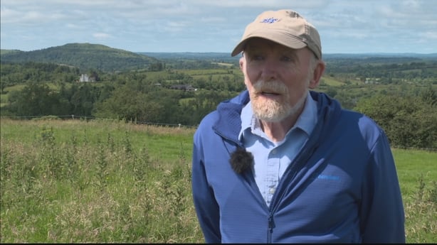 Professor Peter Halligan standing in a field.