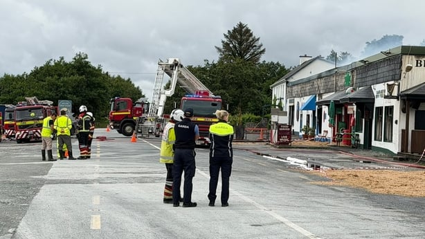 Firefighters assess scene of fire