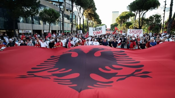 Demonstrators wave a giant Albanian flag outside the Prime Minister's Office during the thirty-fifth consecutive day of protests against a proposed luxury tourism development project in Tirana, Albania, on 4 July, 2026. (Photo by Vlasov Sulaj/NurPhoto)