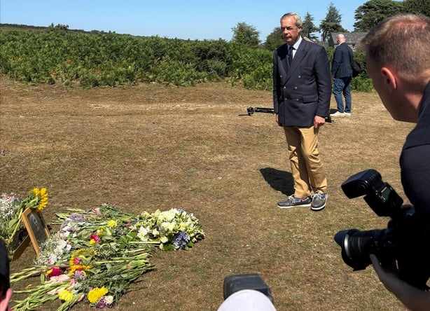 Reform UK leader Nigel Farage lays a wreath near to the home of Ann Widdecombe