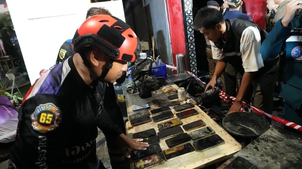 Mobile phones of victims of a fire are recovered in Bangkok,