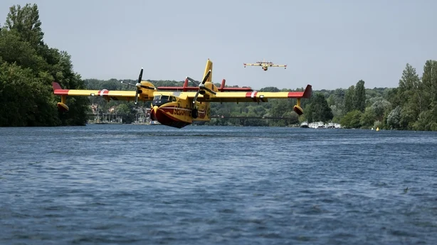 A plane near the water to scoop up water from a river near Paris
