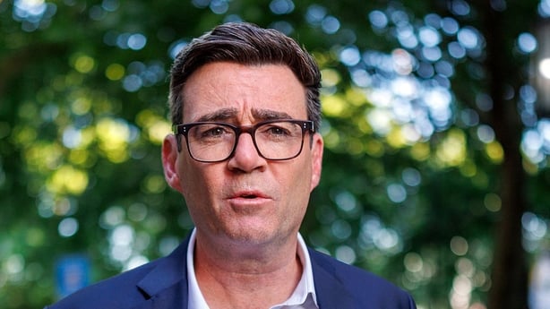 Labour MP Andy Burnham walks through a park in London