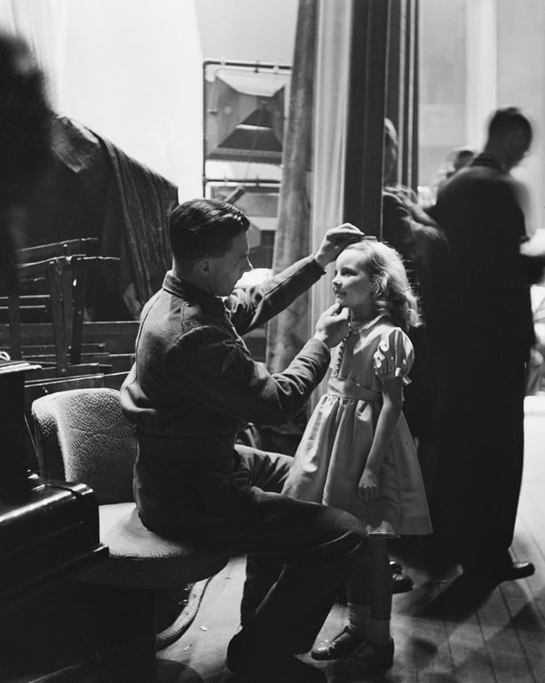 Petula Clark gets a last-minute check from her father, Lance Corporal Leslie Clark, before going on stage at the BBC's Empire birthday party, December 1942. (Photo by Fred Ramage/Keystone Features/Hulton Archive/Getty Images)