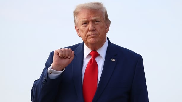 US President Donald Trump motions to reporters after getting off Air Force One on July 22, 2026 at Joint Base Andrews, Maryland